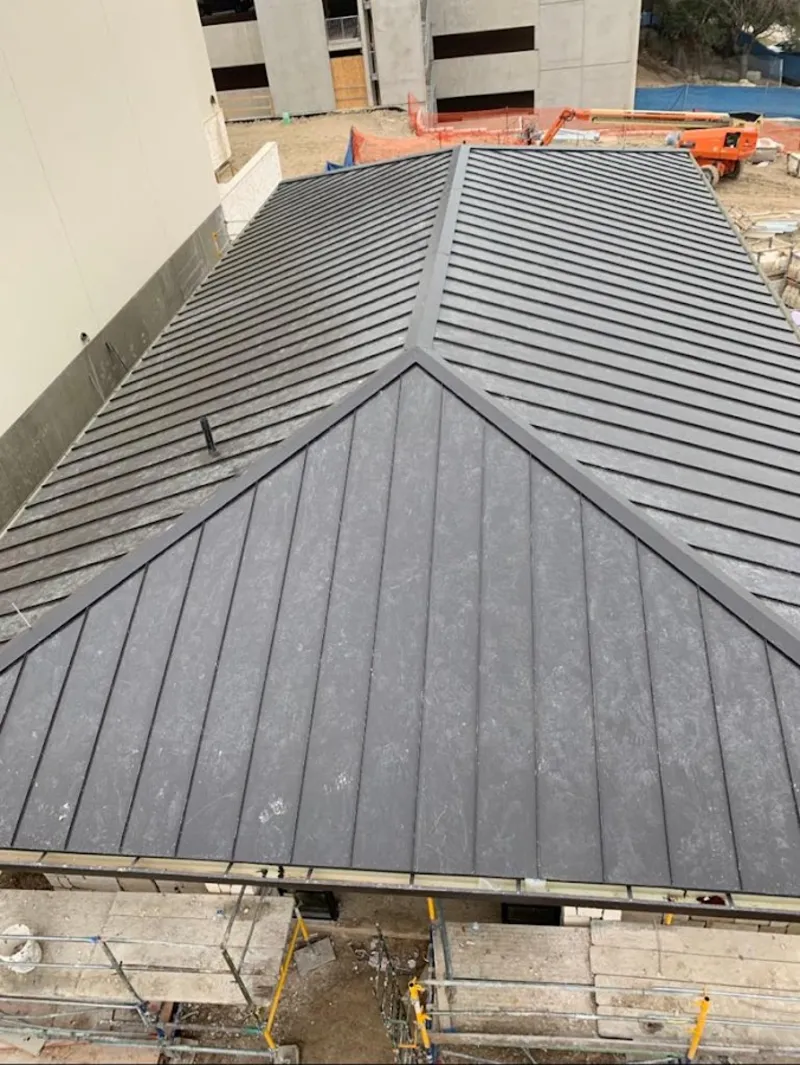 Commercial metal roof construction with crane equipment in Manasquan